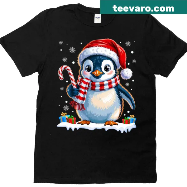 Cute penguin graphic holding a candy cane on a t-shirt.