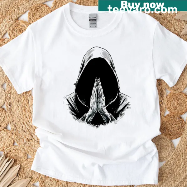 Hooded figure in prayer graphic on a T-shirt