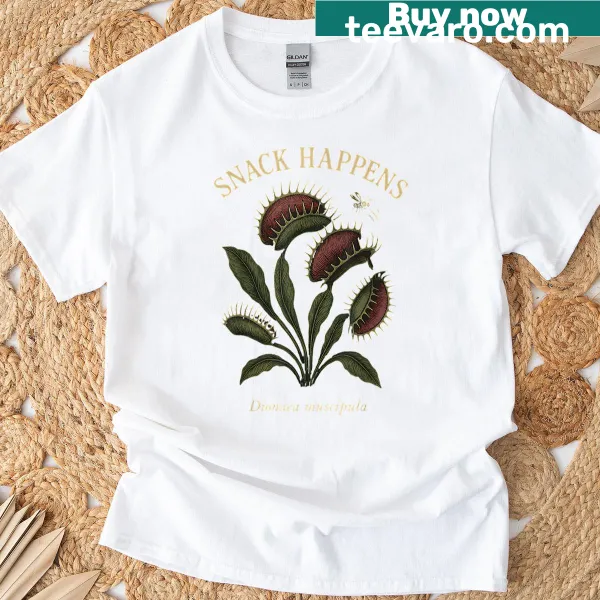 Quirky Venus flytrap graphic tee with 'Snack Happens' text.