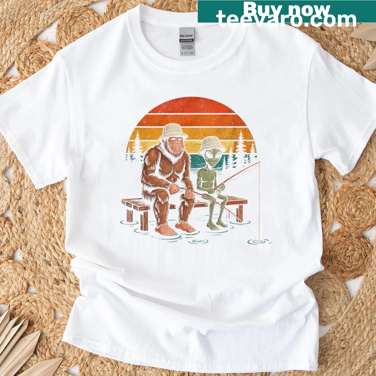 Illustrated funny t-shirt featuring an alien and Sasquatch fishing scene — on a men's t-shirt