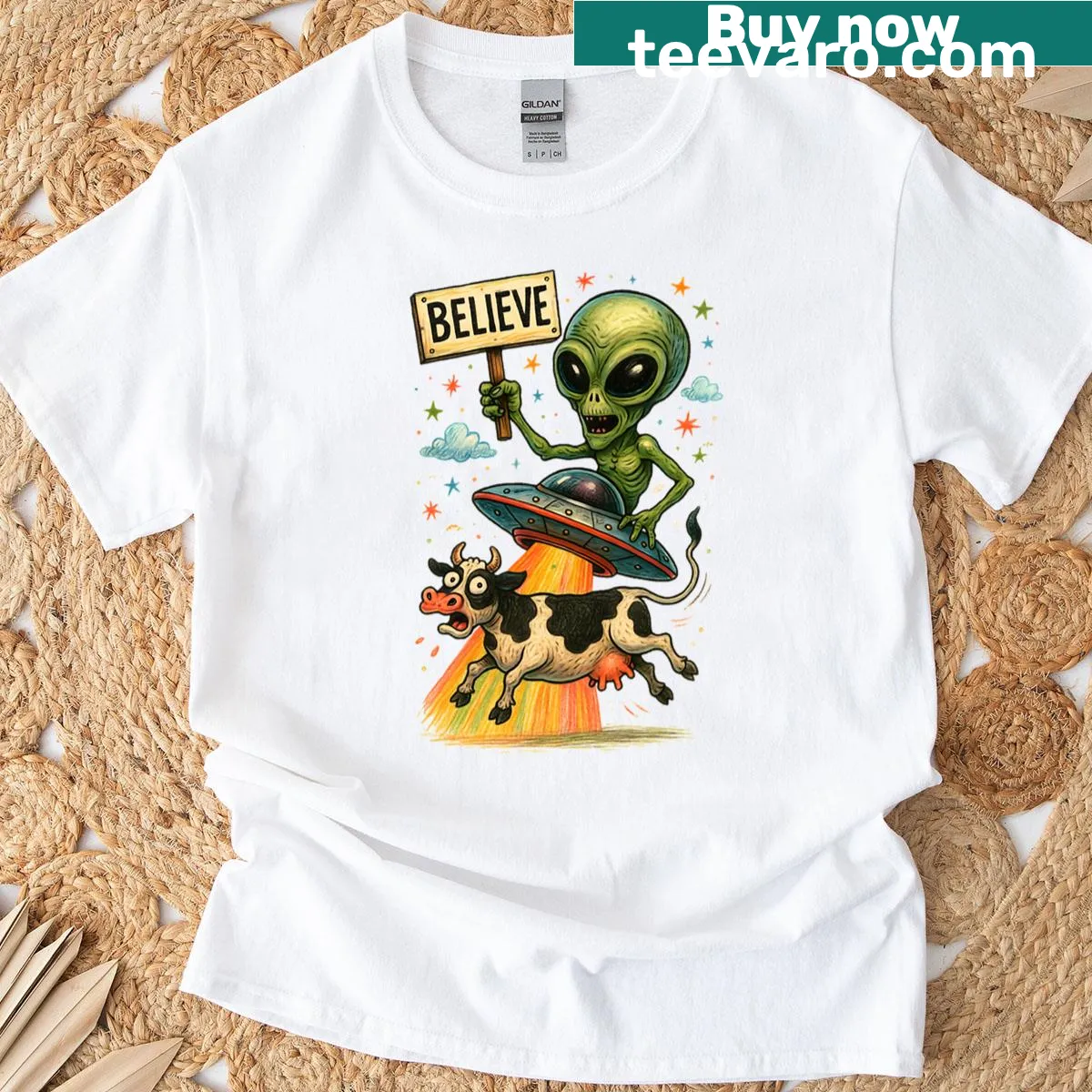 Funny T-shirt featuring a cow being abducted by a UFO — on a men's t-shirt
