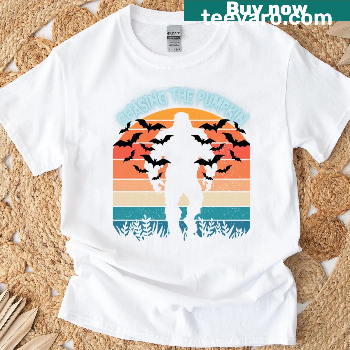 Funny T-shirt featuring Sasquatch chasing a pumpkin at sunset — on a men's t-shirt