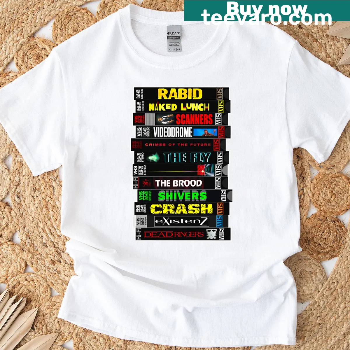 T-shirt with a stack of VHS tapes featuring David Cronenberg horror movies — on a men's t-shirt