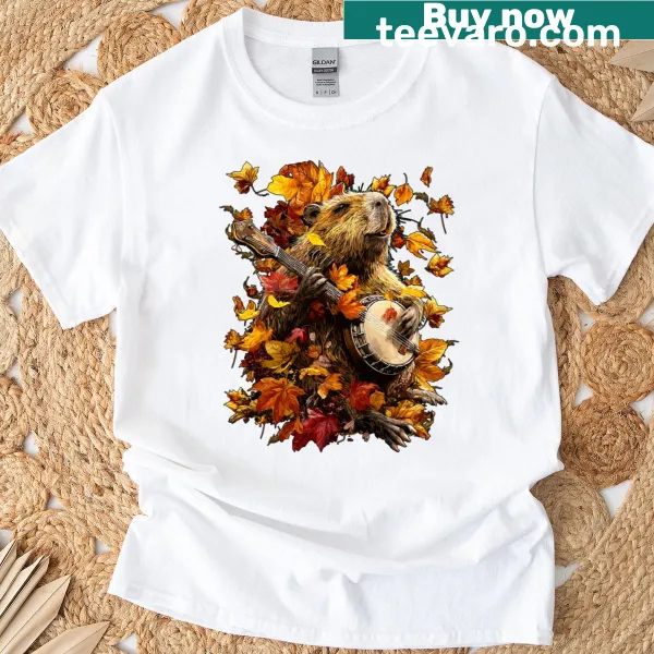 Illustration of a capybara playing a banjo with autumn leaves background on a t-shirt.