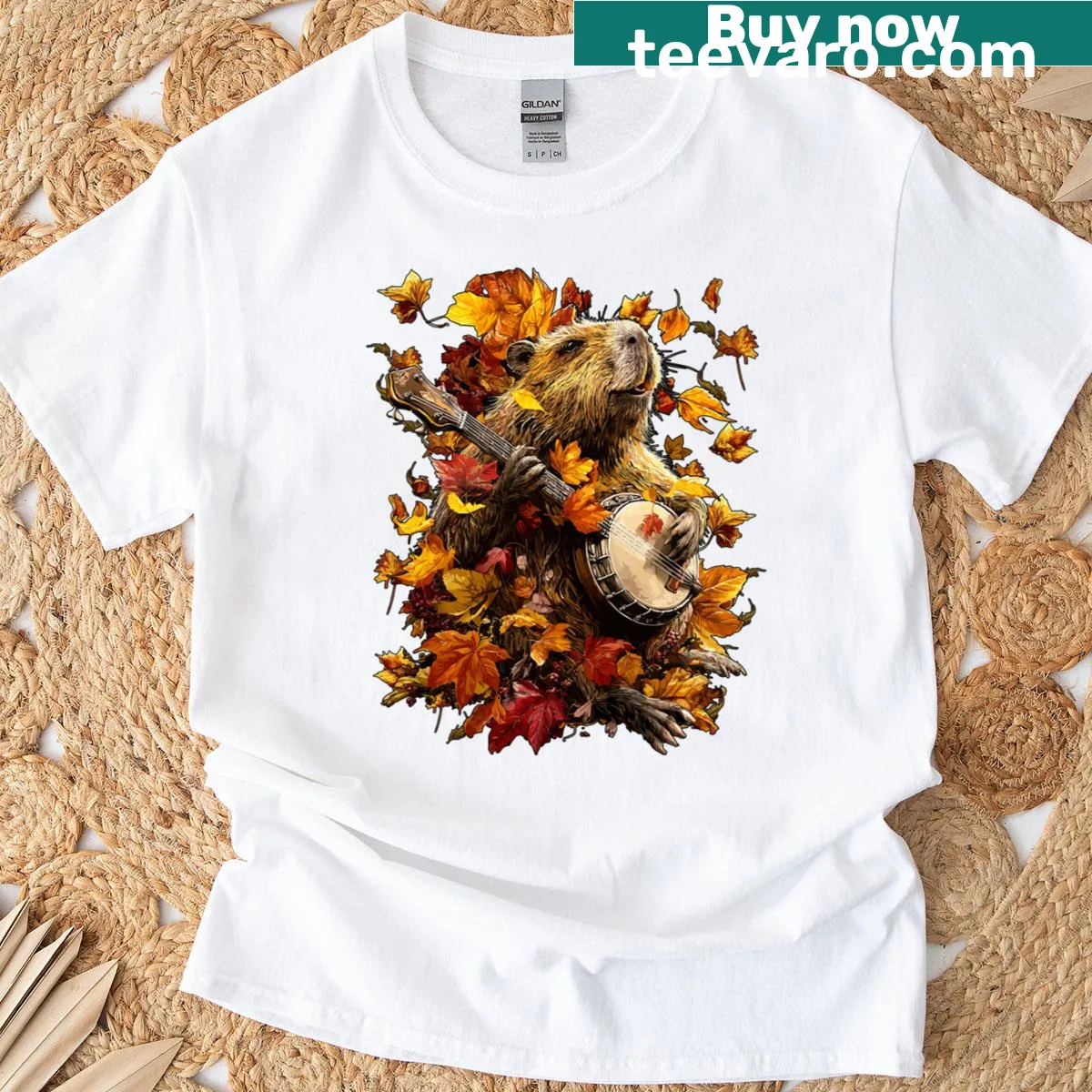 Illustration of a capybara playing a banjo with autumn leaves background on a t-shirt. — on a men's t-shirt