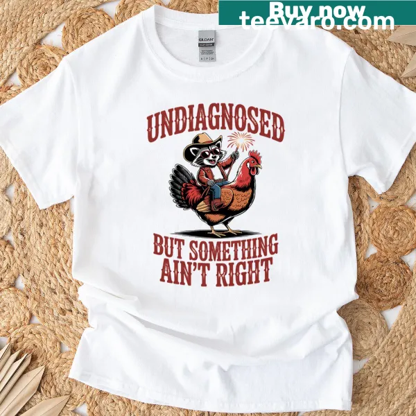 T-shirt with cartoon cowboy raccoon on rooster and fireworks