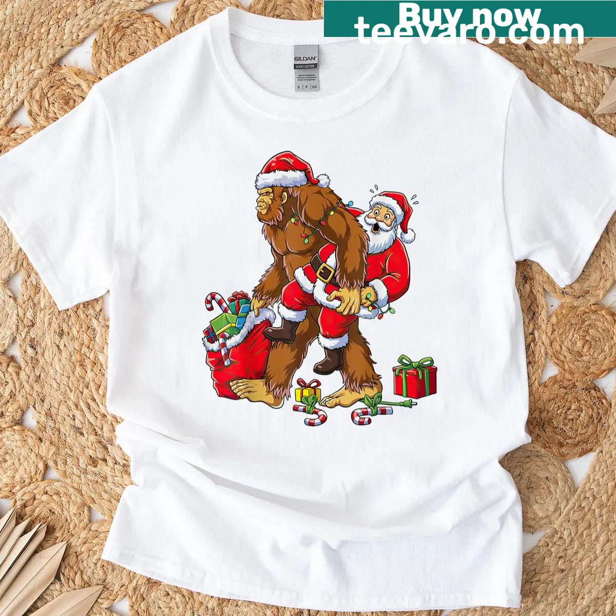 Bigfoot carrying Santa Claus graphic for a funny Christmas t-shirt — on a men's t-shirt
