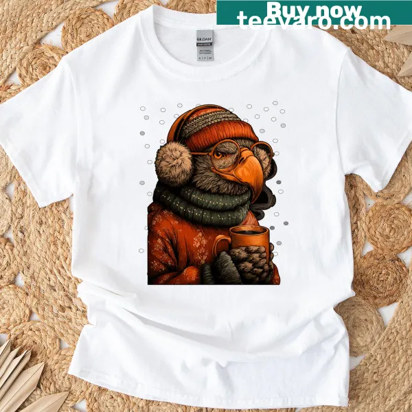Funny winter t-shirt featuring a cute eagle with earmuffs and coffee