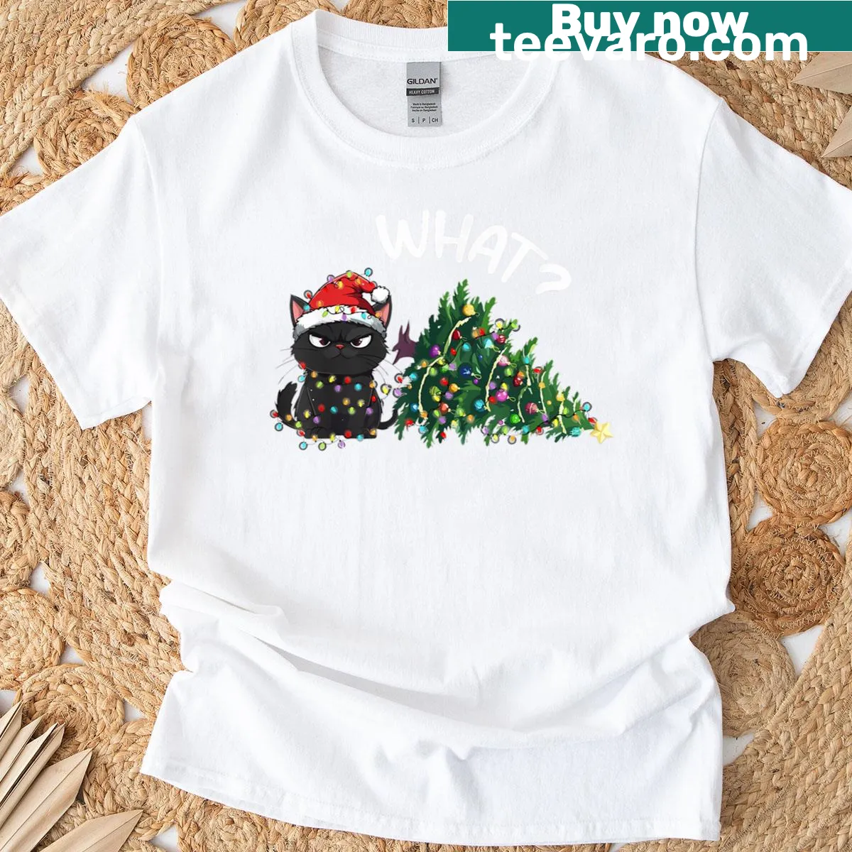 Humorous black cat design contemplating a Christmas tree on a T-shirt. — on a men's t-shirt