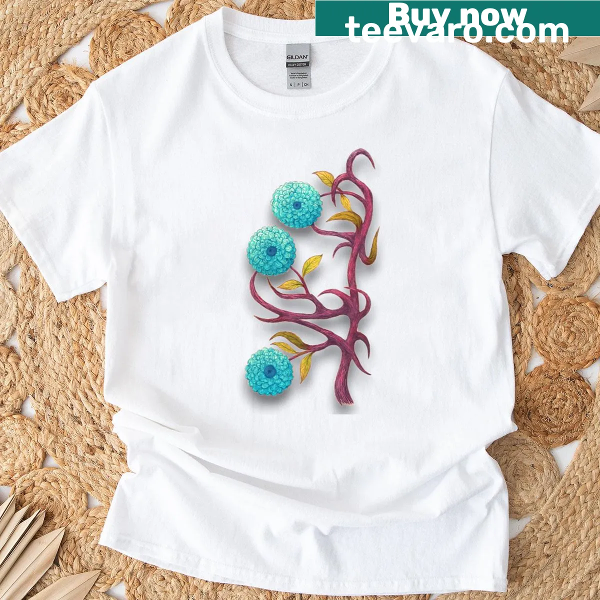 T-shirt featuring a tree design with a blue flower illustration. — on a men's t-shirt