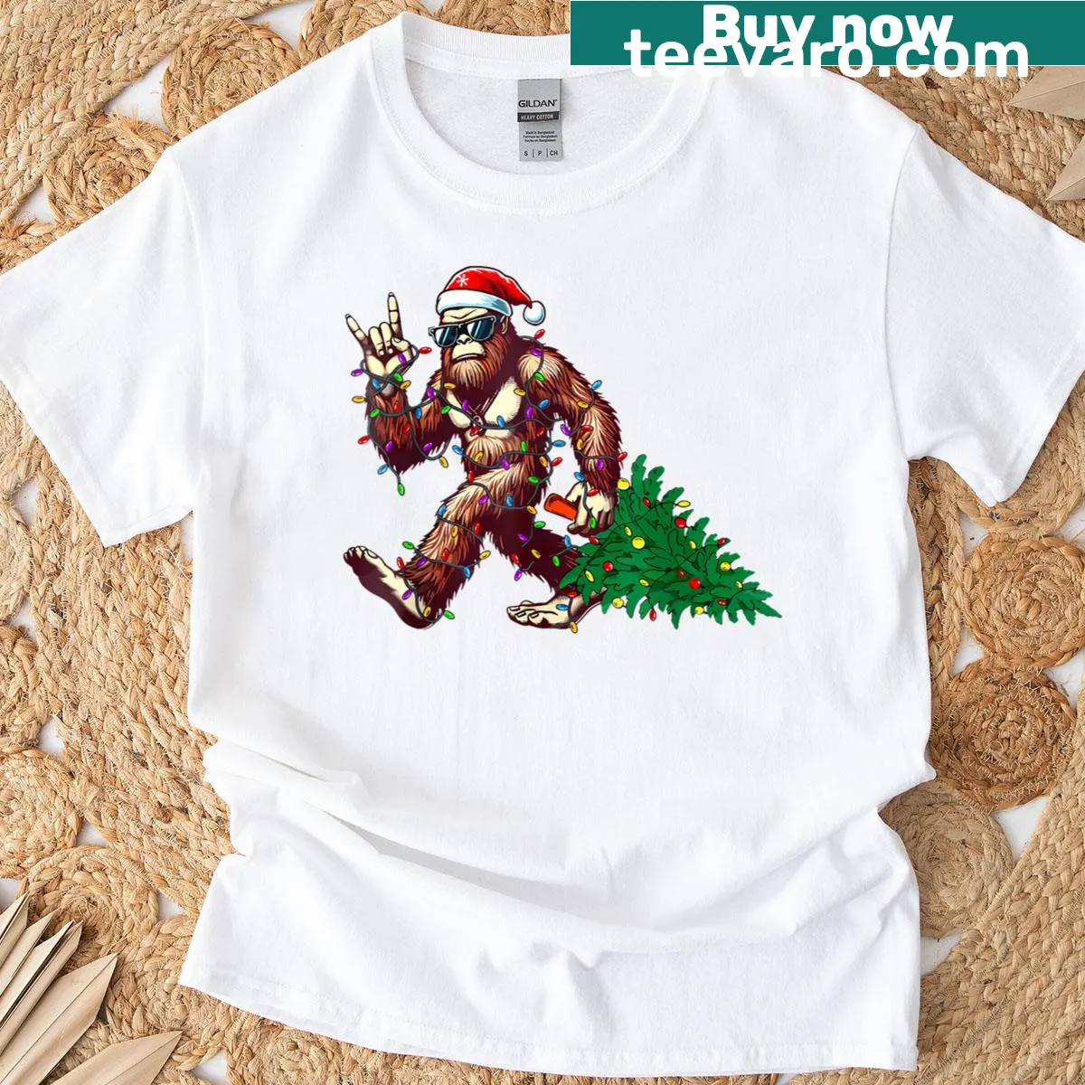 Humorous T-shirt featuring Big Foot in Santa hat with Christmas tree — on a men's t-shirt