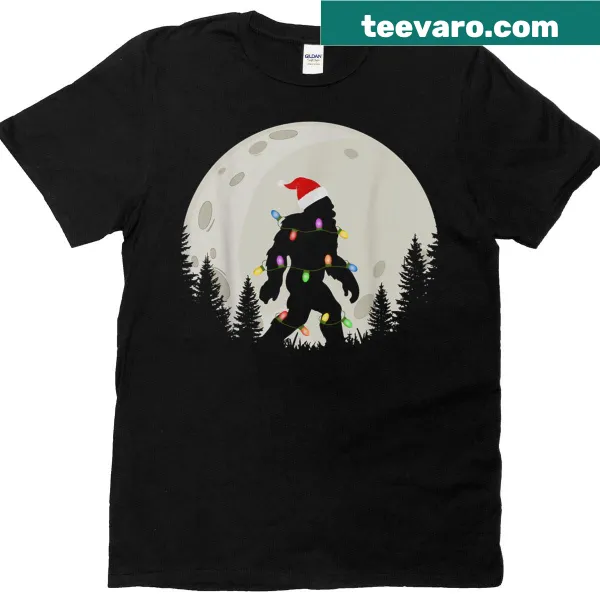 Funny Christmas t-shirt featuring Sasquatch in a Santa hat under the moon