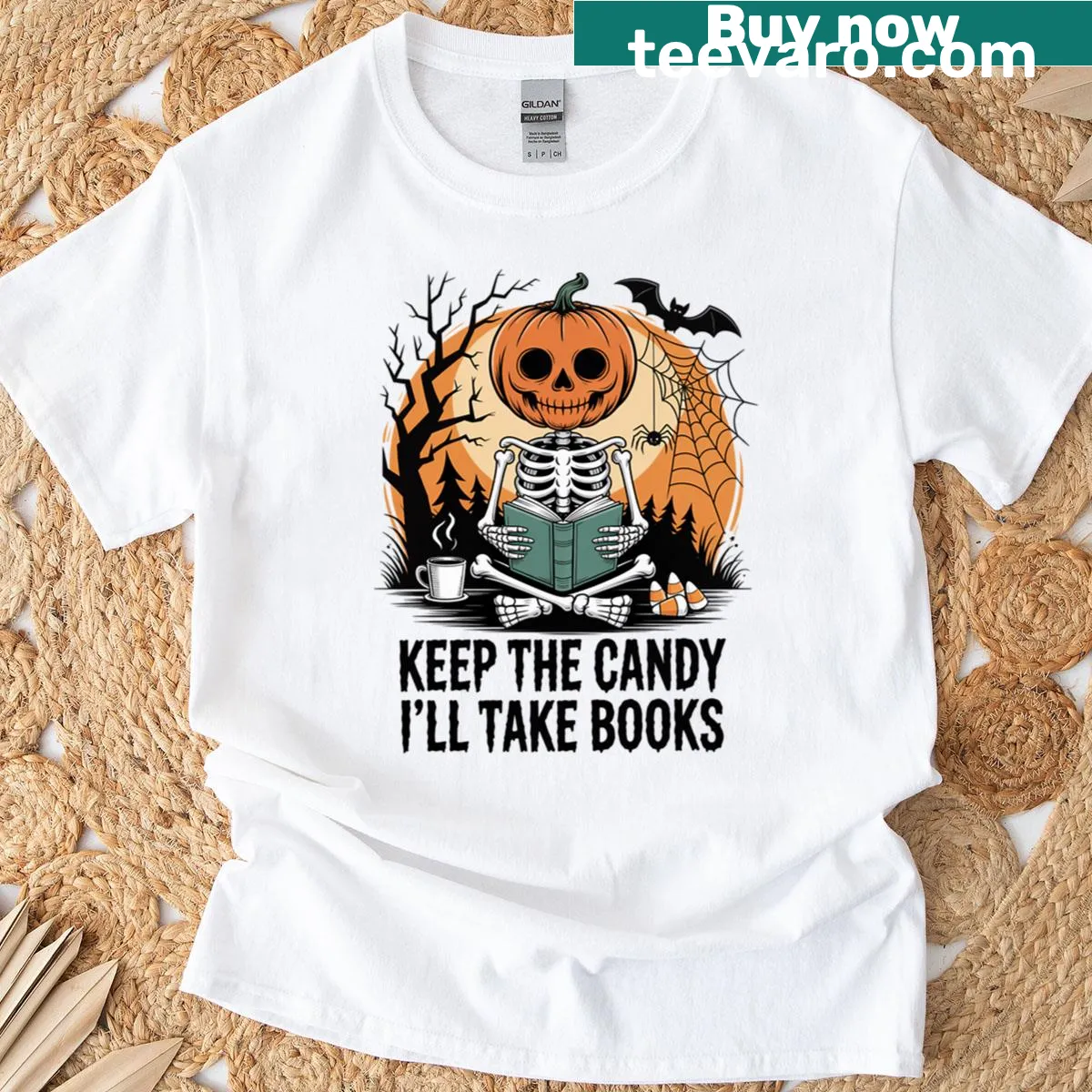 Skeleton with a pumpkin head reading a book for Halloween. — on a men's t-shirt
