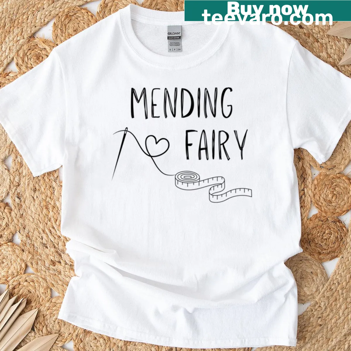 Black and white graphic of a mending fairy with sewing tools — on a men's t-shirt