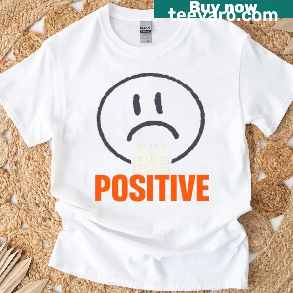 Minimalist t-shirt with a sad face graphic and dark humor