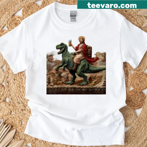 Graphic T-shirt featuring Jesus riding a dinosaur and drinking beer