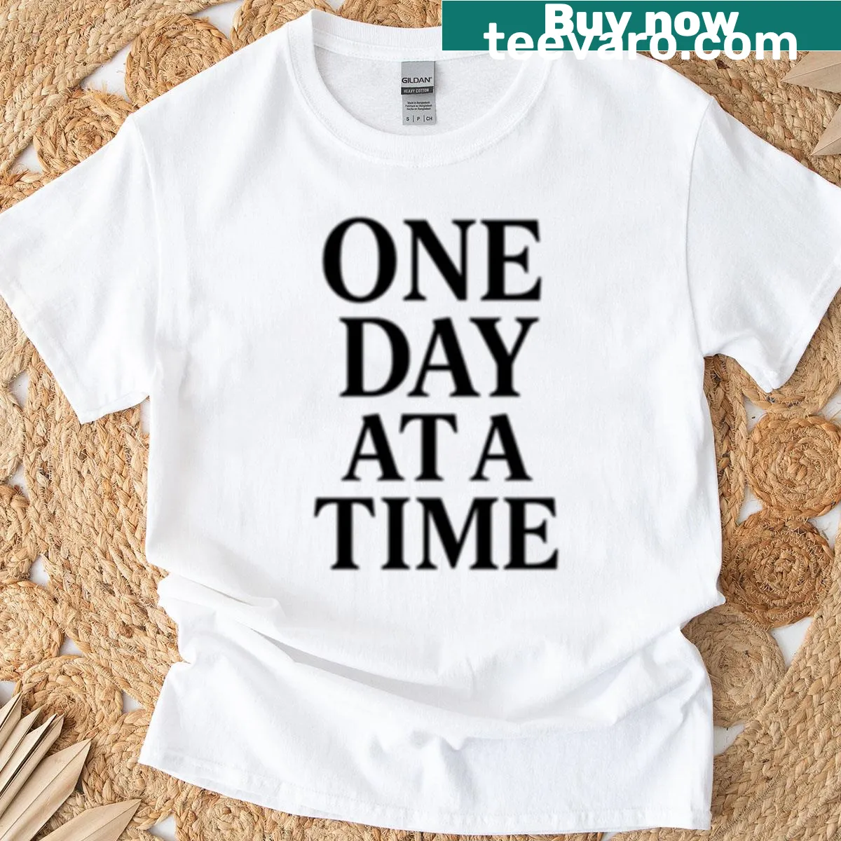 Minimalist motivational t-shirt featuring the phrase 'One Day At A Time' — on a men's t-shirt