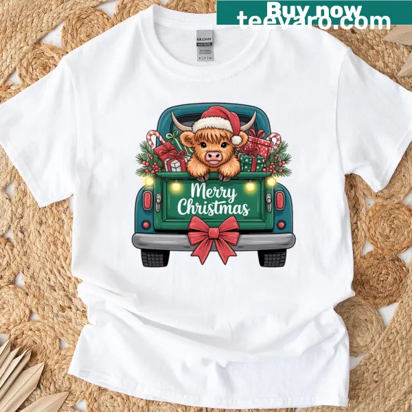 T-shirt featuring a Highland cow in a holiday truck