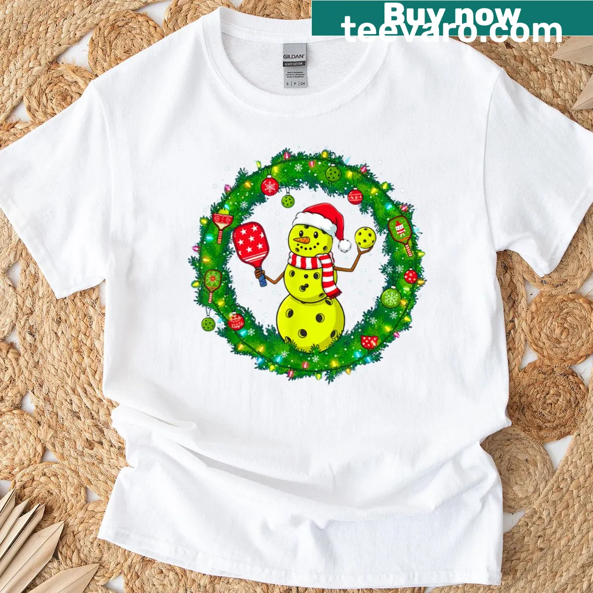 Whimsical Christmas T-shirt with snowman and pickleball theme — on a men's t-shirt