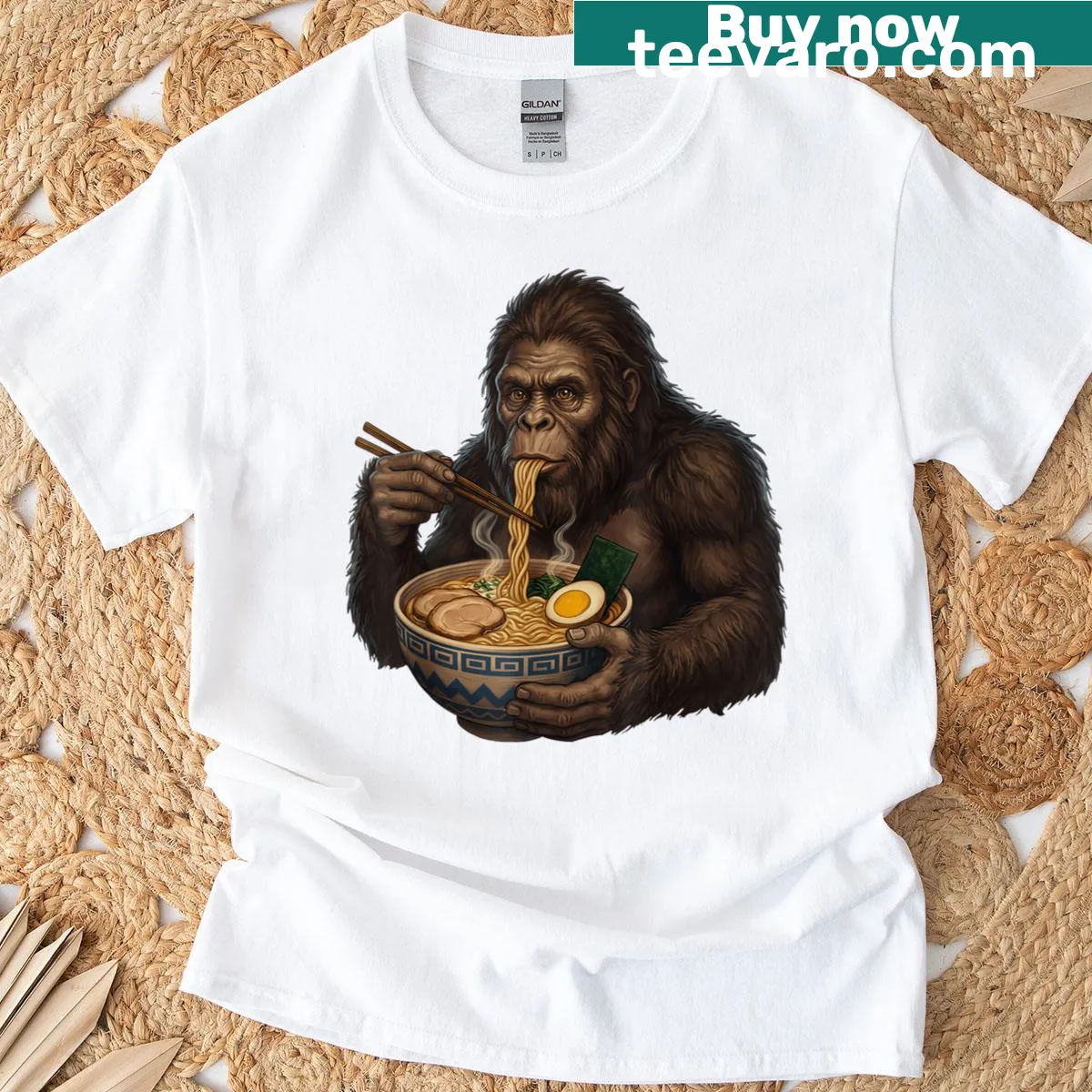 Cartoon Sasquatch eating ramen noodles, humorous graphic t-shirt — on a men's t-shirt