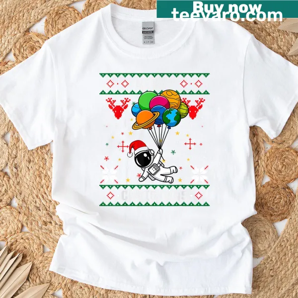 Cartoon astronaut in Santa hat holding a planet with Christmas tree