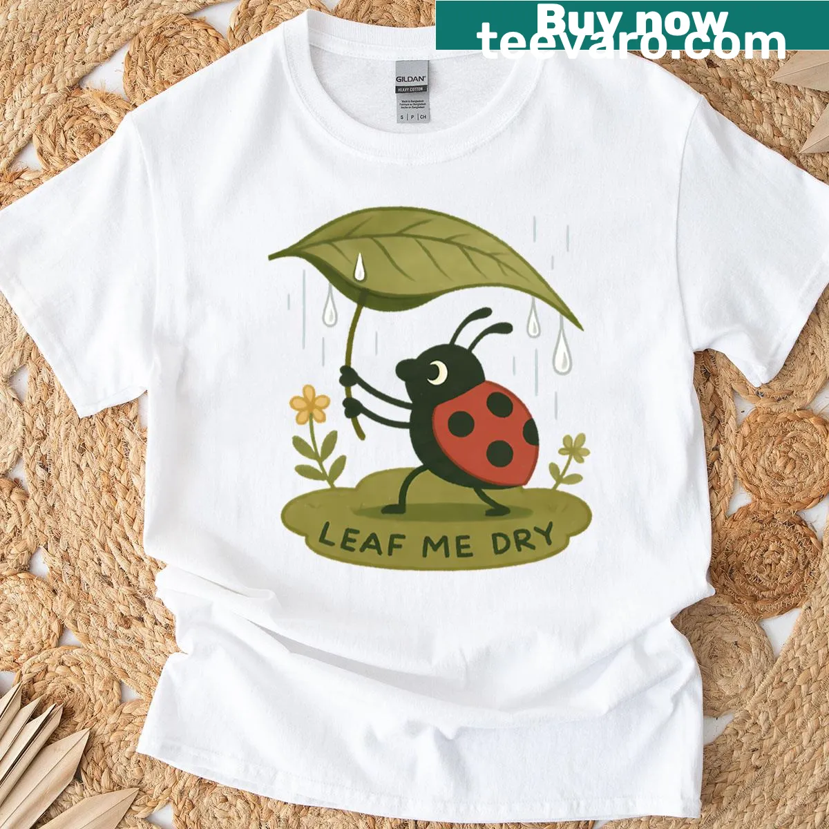 T-shirt featuring a ladybug under an umbrella in a garden setting — on a men's t-shirt