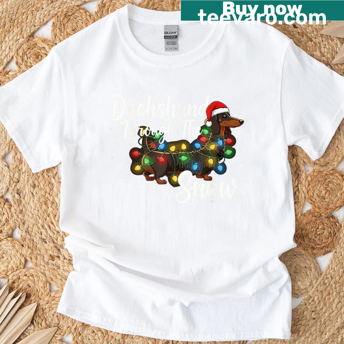 Dachshund in snow graphic on a Christmas-themed T-shirt — on a men's t-shirt