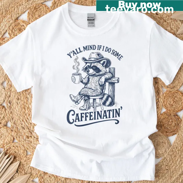Humorous t-shirt featuring a raccoon in a cowboy hat with coffee