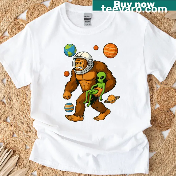 Cartoon t-shirt featuring astronaut, Bigfoot, and aliens in space
