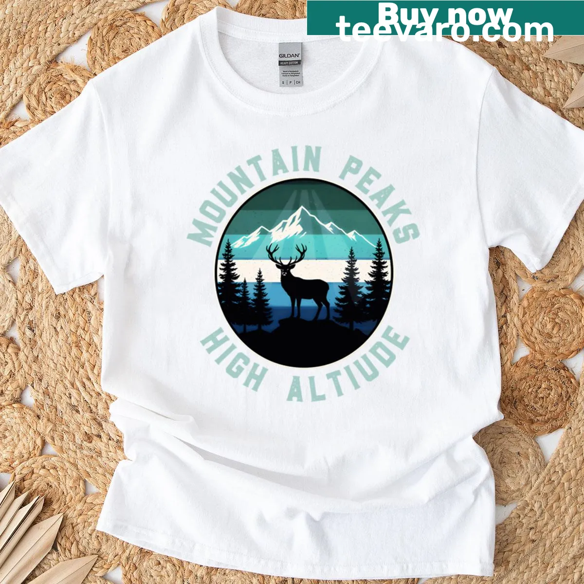Illustrative t-shirt featuring mountain peaks and adventure theme — on a men's t-shirt