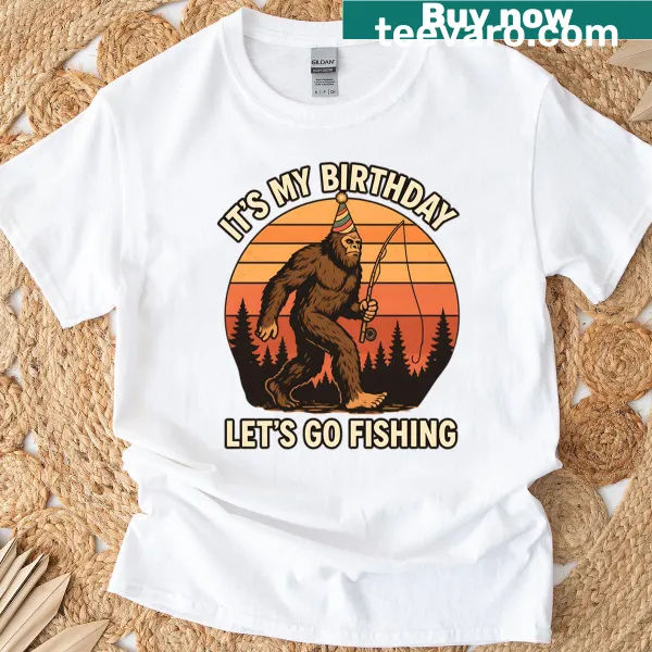 Birthday T-shirt featuring a playful Bigfoot fishing party illustration with retro sunset